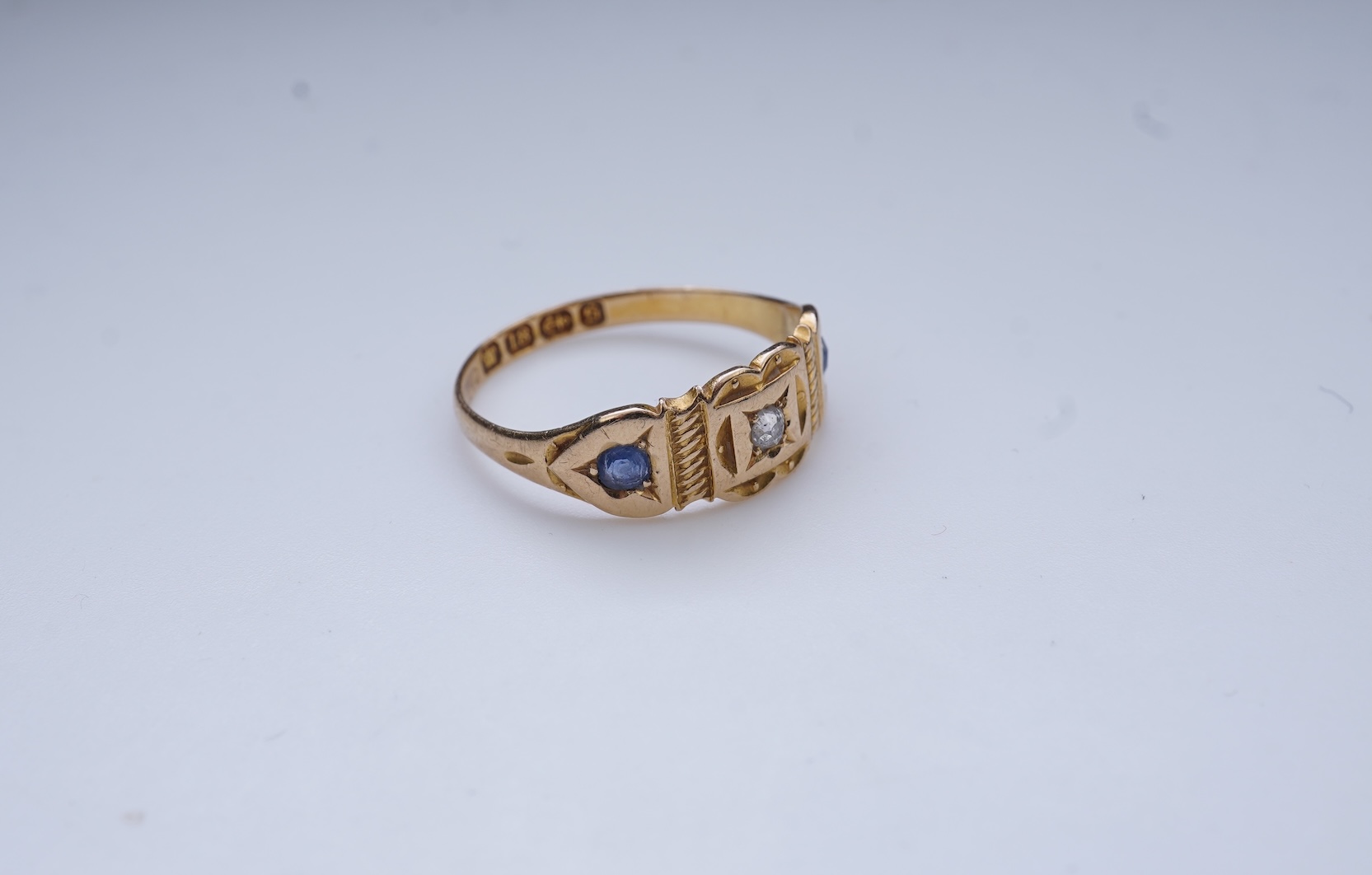 A Victorian sapphire and diamond three-stone ring, circa 1892